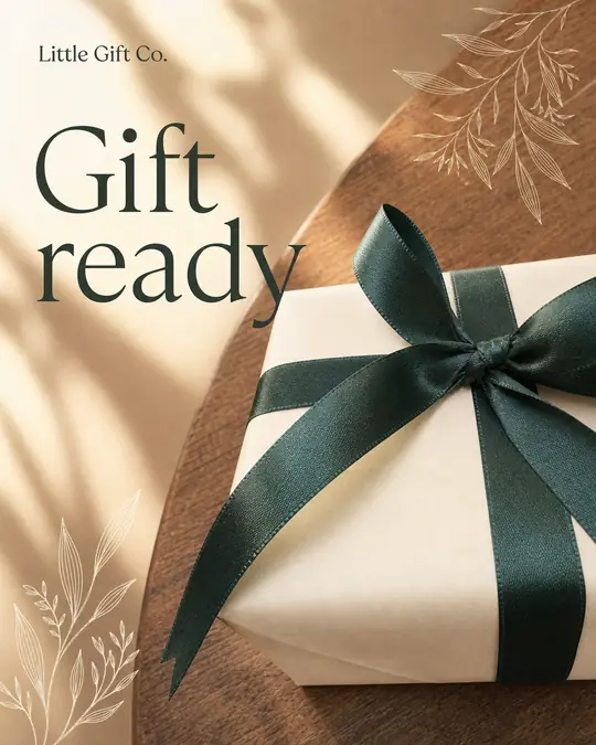 The same gift box on a round wooden table in warm light with sketched leaves, headline Gift ready