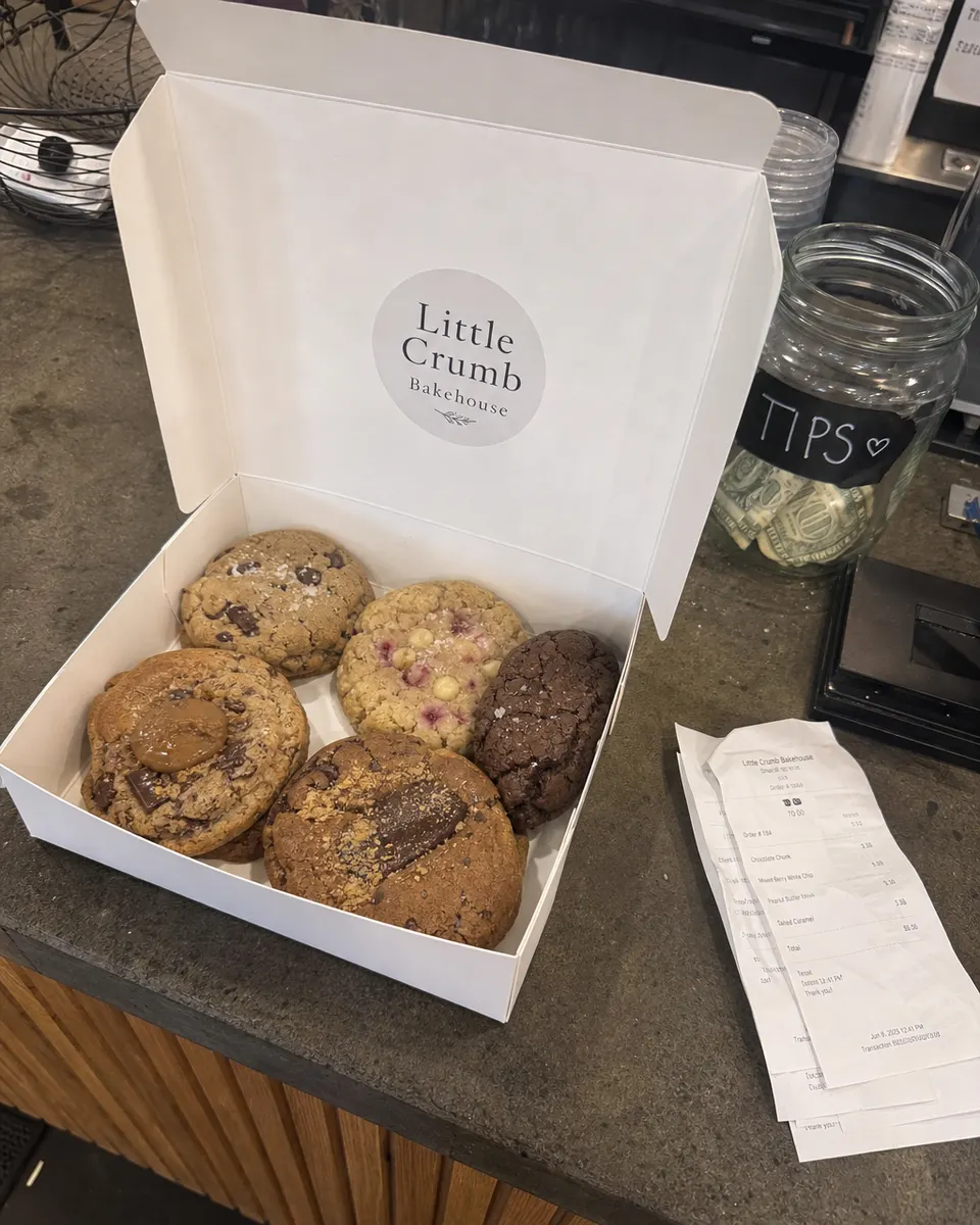 A Little Crumb Bakehouse box of cookies on a café counter